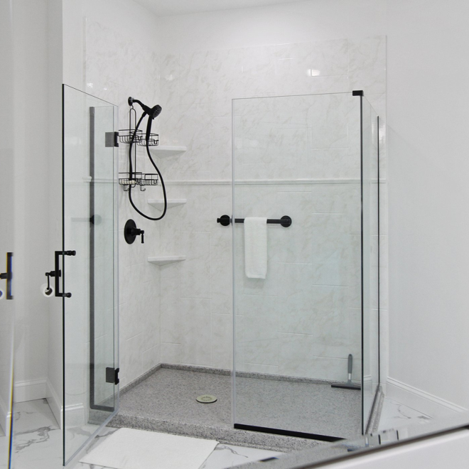 A shower with glass doors
Description automatically generated