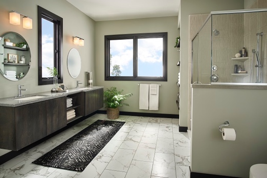 A bathroom with a black rug and a window
Description automatically generated