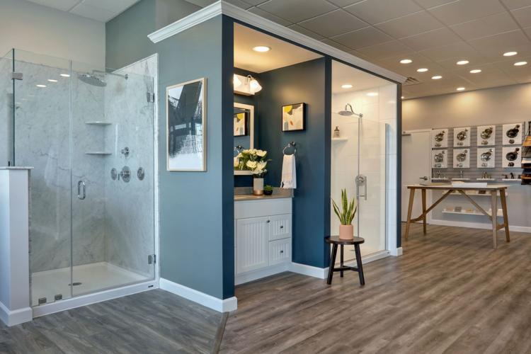 A bathroom with a shower and a wood floor
Description automatically generated