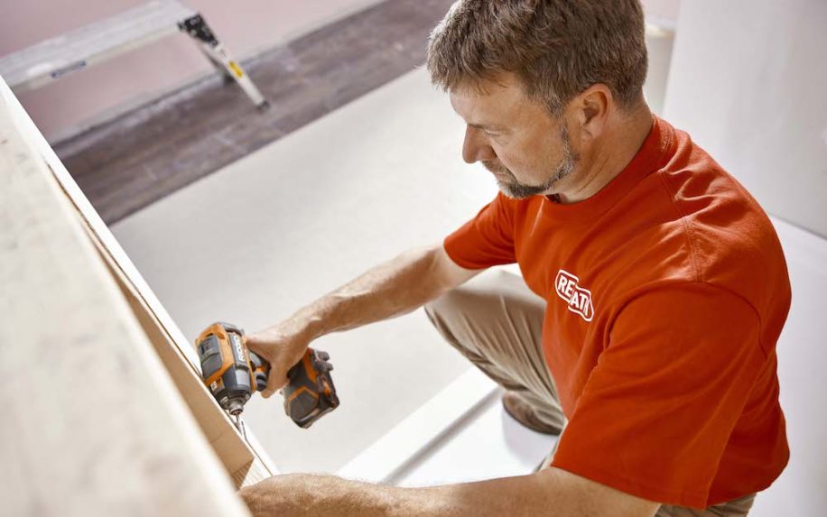man drilling on the wall