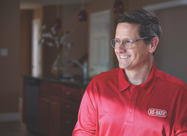 Re-Bath franchisee in red shirt smiling