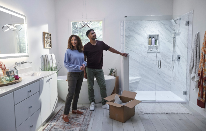 A young couple looks at their new bathroom, under warranty
